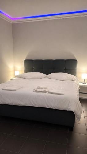 a bedroom with a large bed with white sheets at Das gemütliche Unterkunft in Gelsenkirchen