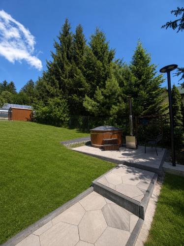 a fire pit in a park with trees and grass at Istebna Pełna Chata II in Istebna