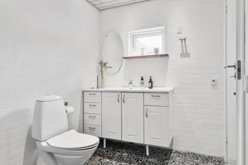 a white bathroom with a toilet and a sink at 20623-Samso-Besser-Hovedgade-9 in Besser