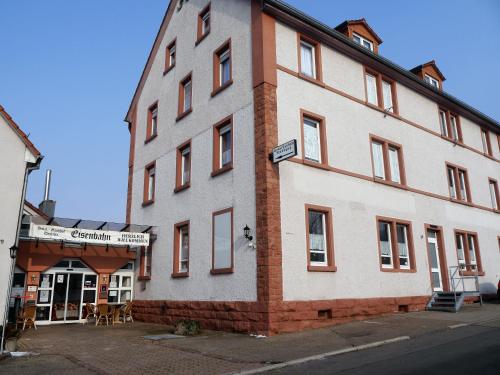 a large white building on the side of a street at Hotel-Gasthof-Destille-Eisenbahn in Mosbach