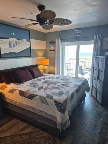 a bedroom with a bed and a view of the ocean at Grand Caribbean in Orange Beach