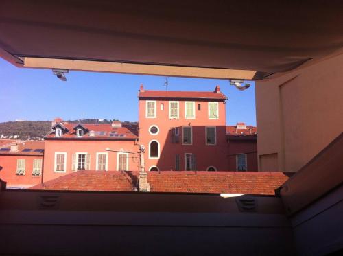 a view of a building from the window of a building at La Mansarde du Port FAMILLY HOME in Nice