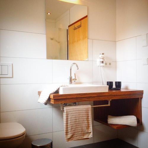 a bathroom with a sink and a toilet at Apart Sportiva in Klösterle am Arlberg