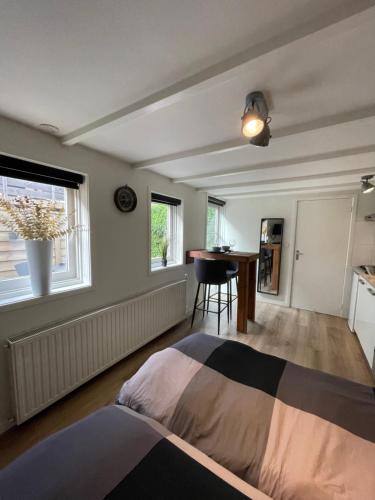 a living room with a bed and a kitchen at B&Beach Zandvoort in Zandvoort