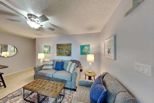 a living room with a couch and a table at Beachside Villas #413 in Seagrove Beach