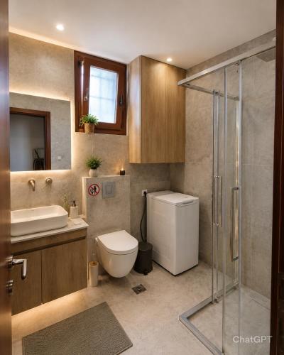 a bathroom with a toilet and a sink and a shower at Luxury Villa Evans 4BR Sleeps 8 Near Beach in Kokóni