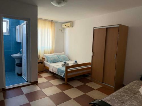 a small bedroom with a bed and a bathroom at Apartment Dasic in Bar