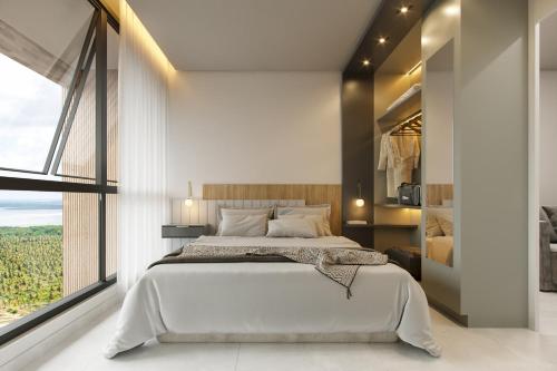 a bedroom with a large bed and a large window at BEACH GAV Resorts in Salinópolis