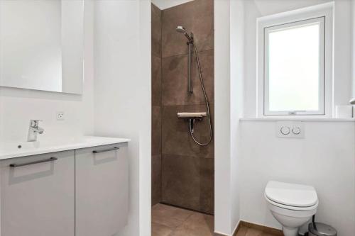 a bathroom with a shower with a toilet and a sink at OH591-Storvorde-Pilekrogen-15 in Skelby