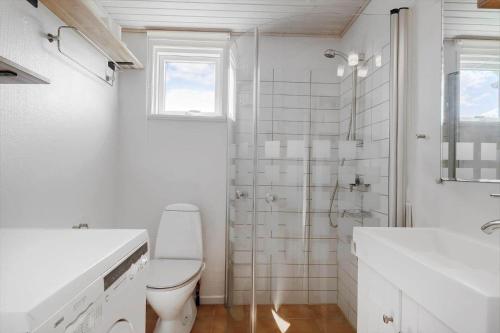 a white bathroom with a toilet and a sink at OH592-Hadsund-Haslevgaarde-Bakker-12 in Øster Hurup