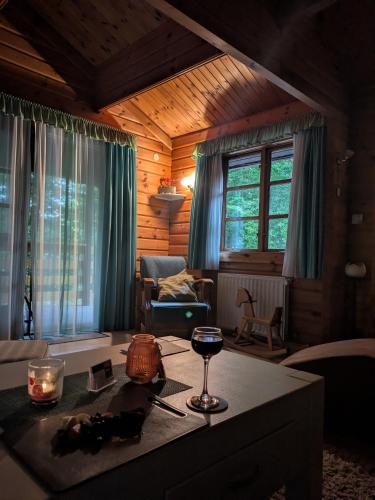 a living room with a table with a wine glass at Kleine Auszeit am Twistesee in Bad Arolsen