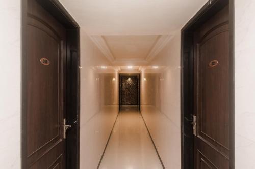 an empty corridor in a building with doors open at Super Hotel O Solitaire in Turambhe