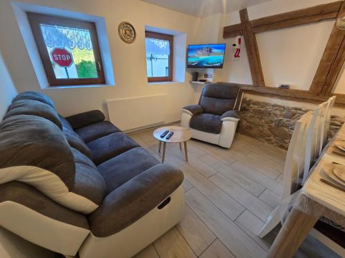 a living room with a couch and a stop sign at La vallée de la bruche in Wisches