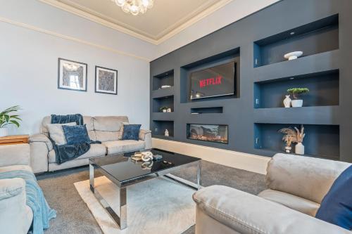 a living room with two couches and a tv at Bay Apartment 2 in Morecambe