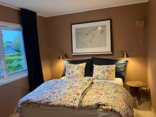 a bedroom with a bed and a window at Bright and central apartment in Stavanger