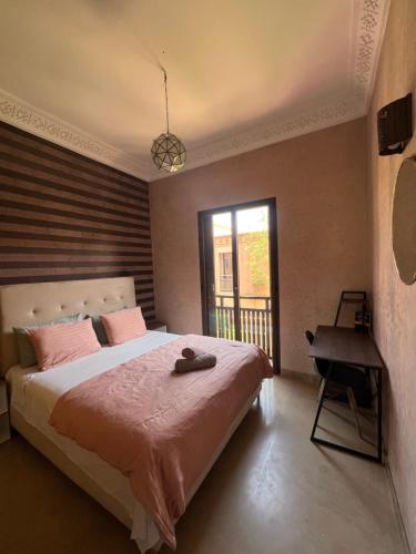 a bedroom with a large bed and a window at Resort Apartment Golf View in Marrakesh