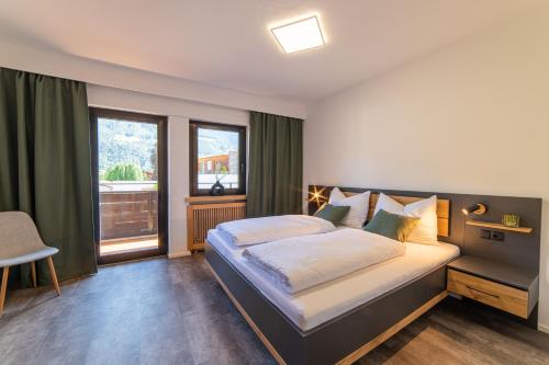 a bedroom with a large bed and a window at Moar Apartments in Silandro