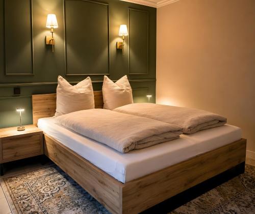 a bedroom with a large bed with white pillows at Ferienwohnung Marina in Wiesmoor