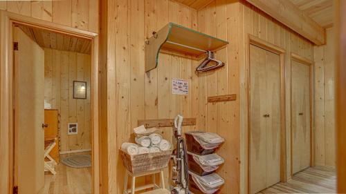 a room with a wooden wall with a rack and baskets at Moosewood Cabin - Meredith Lodging in Government Camp