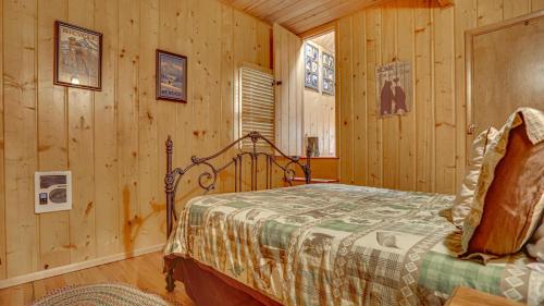 a bedroom with a bed in a log cabin at Moosewood Cabin - Meredith Lodging in Government Camp