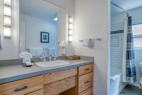 a bathroom with a sink and a shower at Breakers Beach House 7 in Neskowin