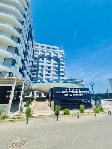 a large building with a sign in front of it at NATALIA - Building Stefan Resort II in Năvodari