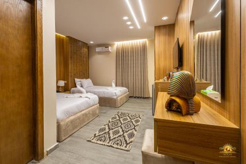 a hotel room with two beds and a room with two beds at Solis Pyramids View Hotel in Cairo
