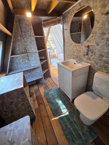 a bathroom with a toilet and a sink at Green Glamping Paravia in Krasica