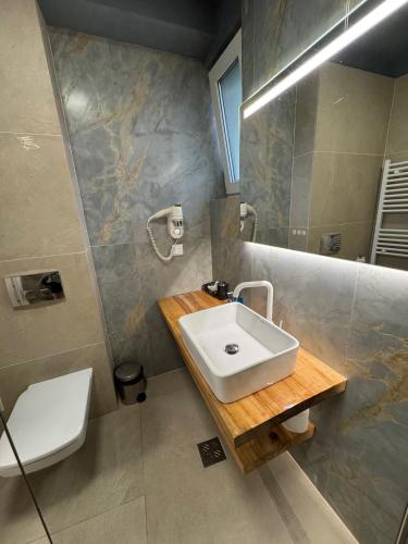 a bathroom with a sink and a toilet at Lucas 10 Apartments in Cluj-Napoca