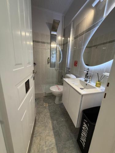 a white bathroom with a sink and a toilet at The Big apartment Papa Nero Pelion in Agios Ioannis Pelio
