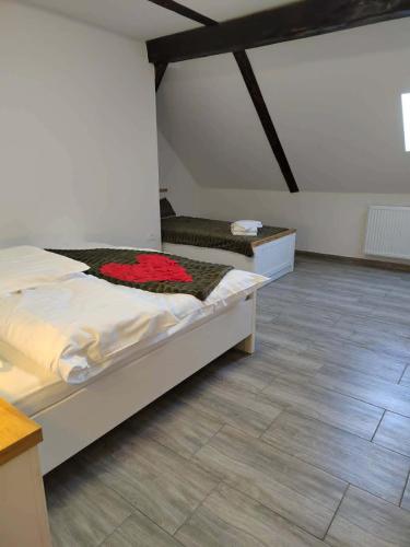 a bedroom with two beds and a wooden floor at Raj pod Košenjakom in Dravograd