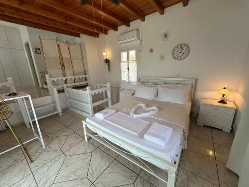 a bedroom with a bed and a clock on the wall at Rocky Beach House in Kythira