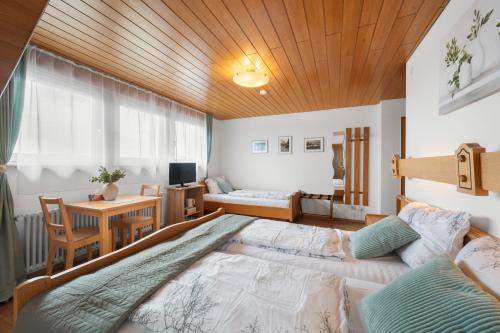 a bedroom with a large bed and a desk at Ferienhaus Seehang in Meersburg