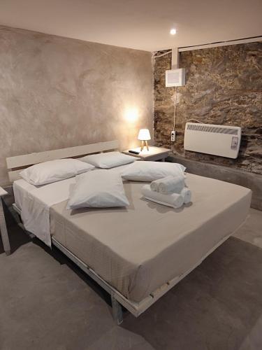 a bedroom with a large bed with a television on the wall at Kamara 1898 katoi in Mouresi