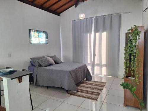a bedroom with a bed and a large window at Rainha do gelo in Barra Grande