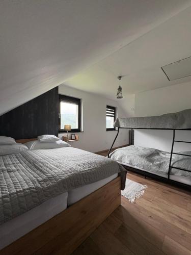 a large bedroom with a large bed and a window at Chata Snowee Valča in Stará Turá