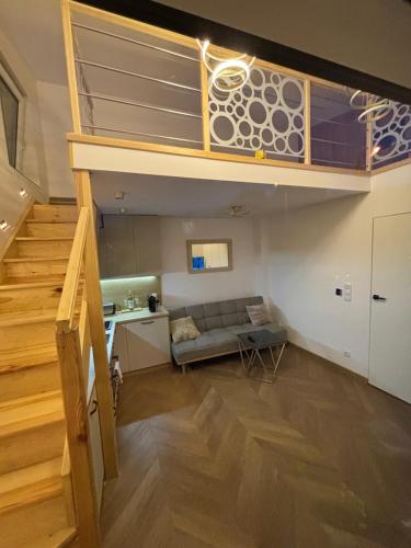 a living room with a loft bed and a couch at Apartament Ana in Lublin