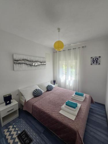 a bedroom with a large bed with two pillows on it at Apartment Loza Senj in Senj
