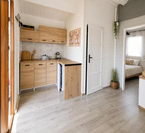 a kitchen with wooden cabinets and a counter top at Domek LENA in Giżycko