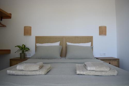 a bed with two towels on top of it at Guesthouse Morito in Ierissos