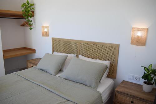 a bedroom with a bed with two pillows at Guesthouse Morito in Ierissos