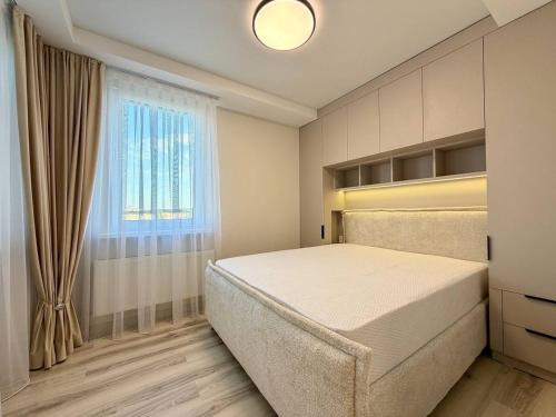 a bedroom with a large bed and a window at Home sweet home 2 in Chişinău