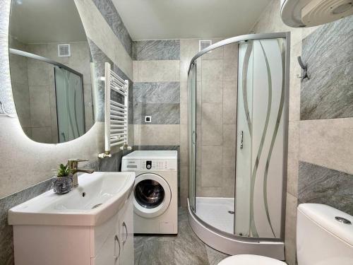 a bathroom with a washing machine and a washer at Home sweet home 2 in Chişinău