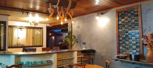 a restaurant with a table and a counter in a room at Espaço Vintage Hospedaria Suíte Alento in Prados