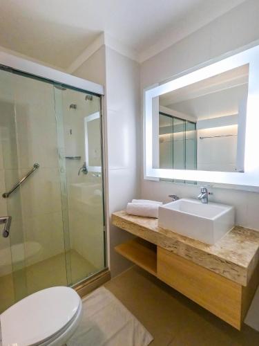 a bathroom with a sink and a shower at Stay Inn Santos in Santos