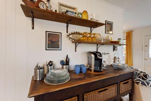 a kitchen with a wooden counter with dishes on it at 5041 - The Captains Quarters in Kill Devil Hills