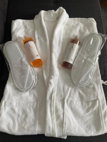 two bottles of soap on a white towel at ToP-HILL in Trebinje