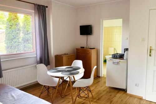 a small kitchen with a table and chairs in a room at Pokoje Gościnne AKACJA in Swornegacie