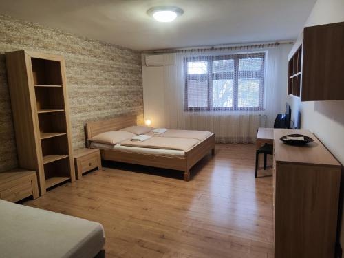 a small bedroom with a bed and a window at Gloria in Olomouc