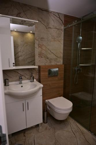a bathroom with a toilet and a sink and a shower at Apartments Gajić with Private Free Parking - New & Modern in Bar